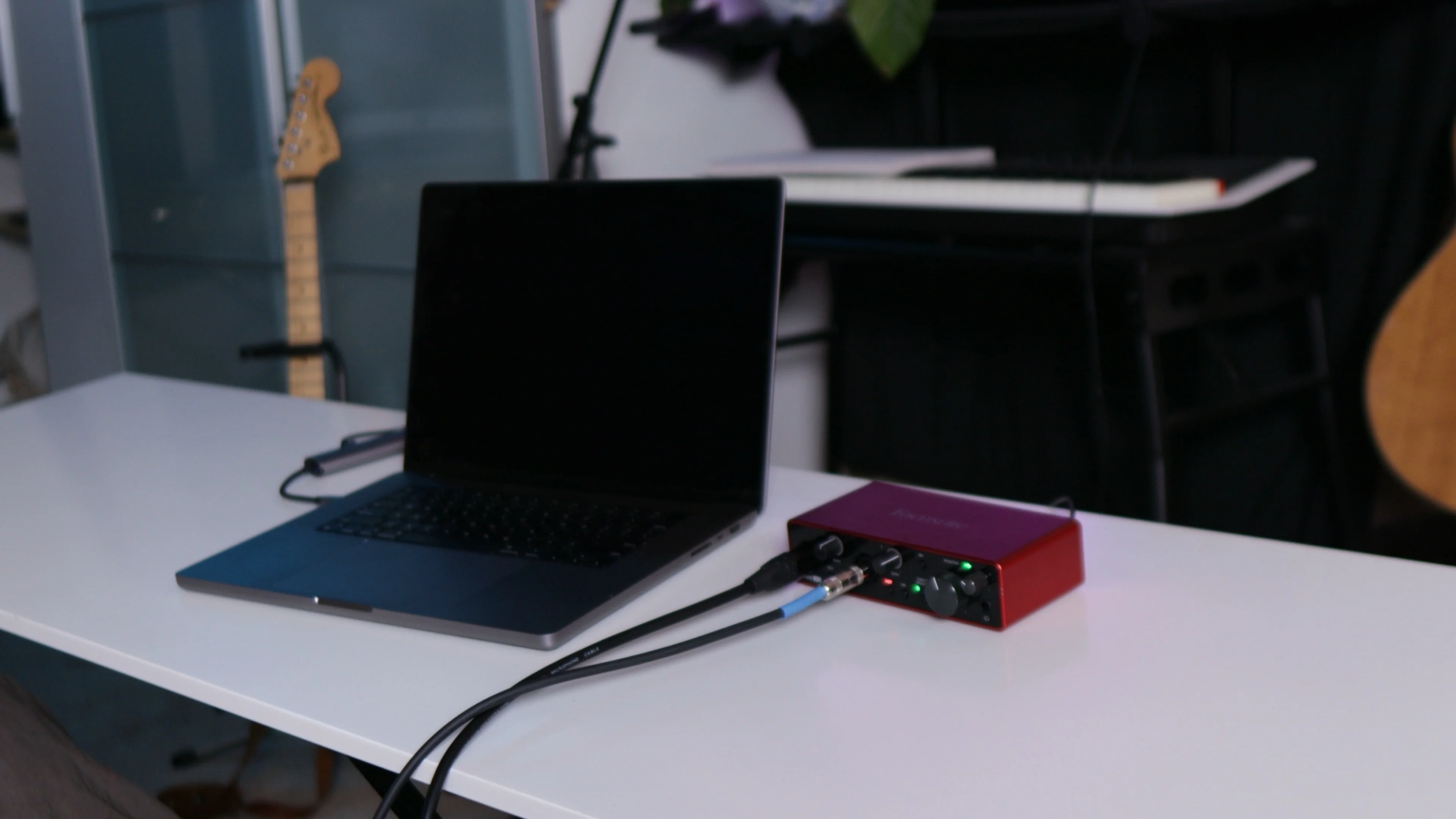 Home studio recording setup with audio interface and laptop, emphasizing the importance of proper recording chain for vocal mixing success