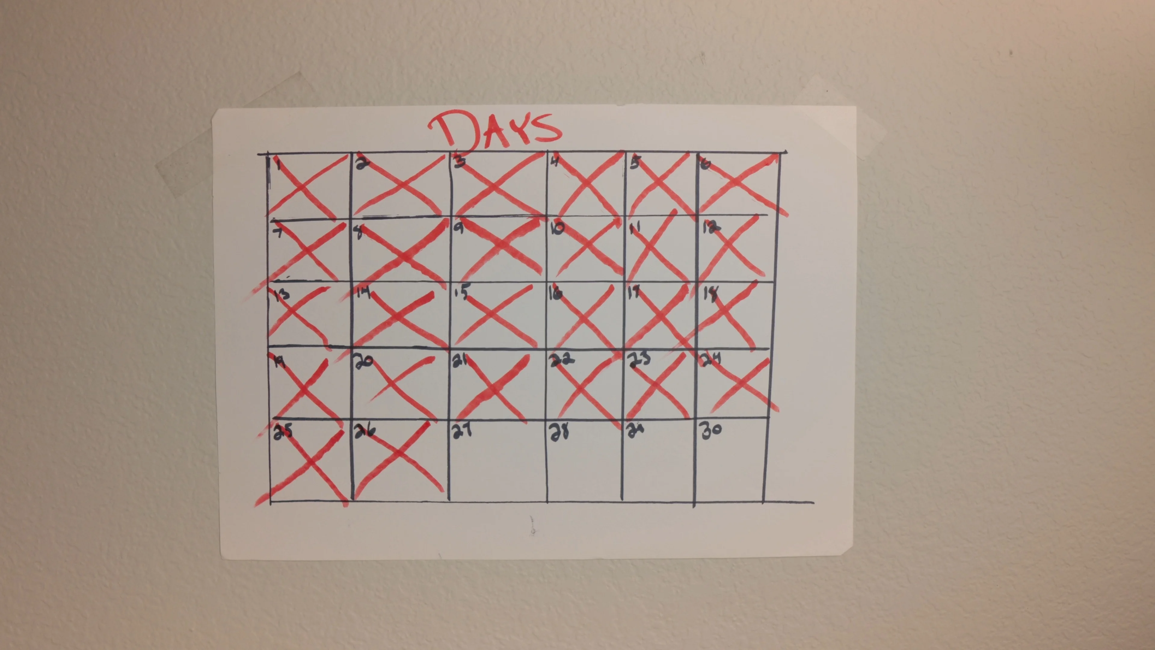 Hand-drawn calendar with red X marks tracking daily songwriting progress, showing commitment to developing lyric writing skills