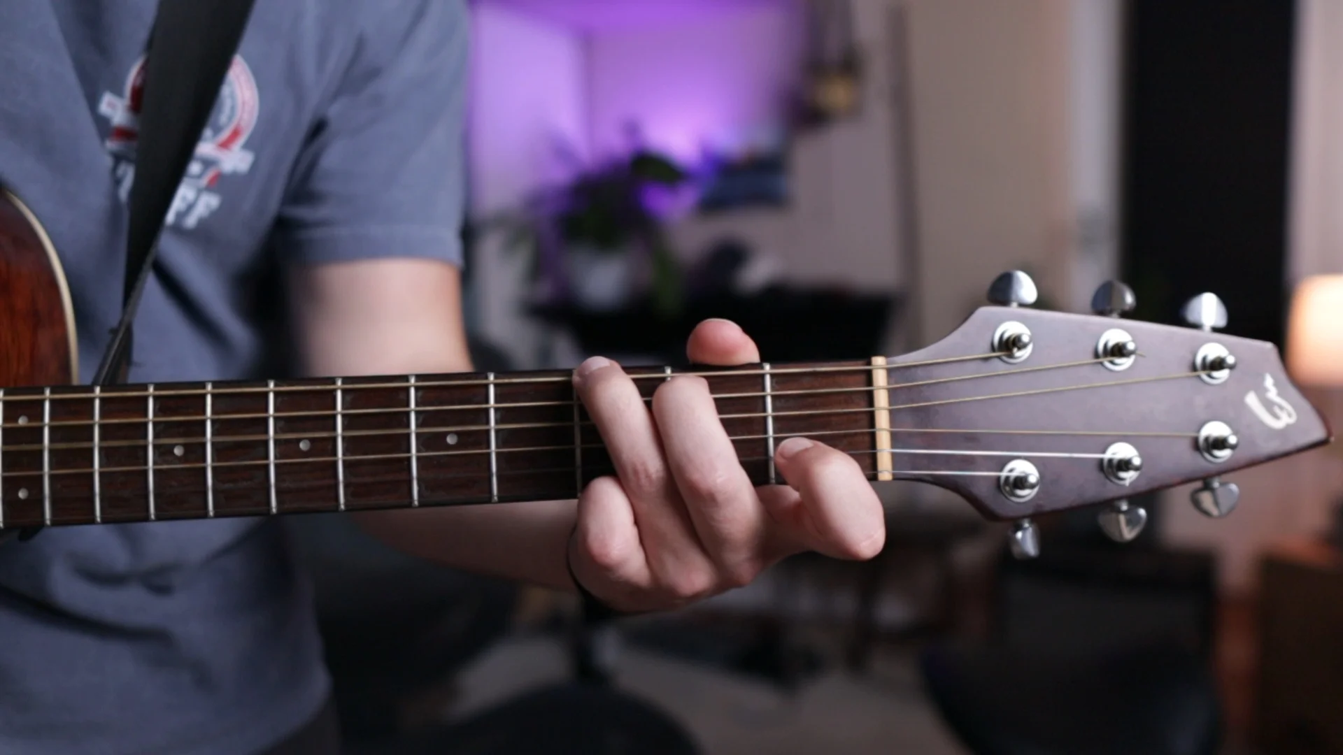 Mattie playing acoustic guitar chords, demonstrating how musical elements work together in a song