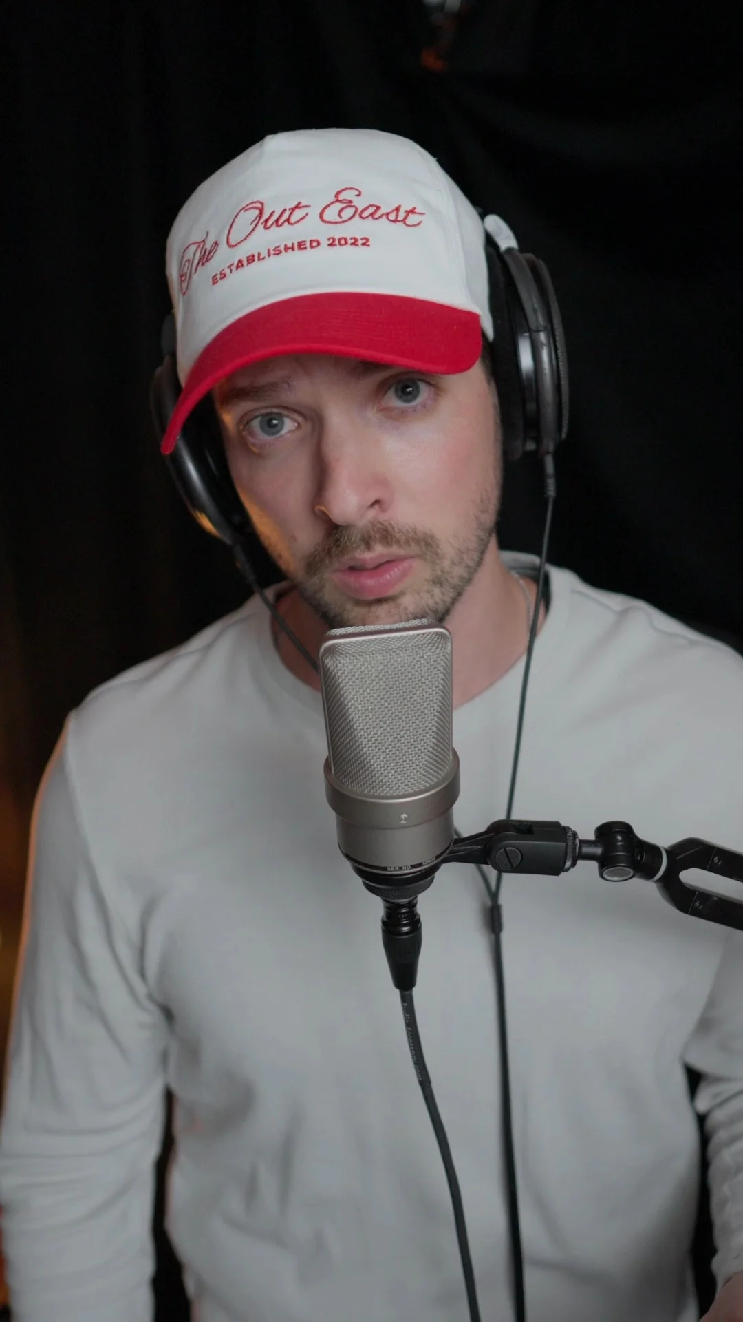 Mattie recording vocals with professional condenser microphone and headphones in studio, demonstrating vocal preset recording techniques