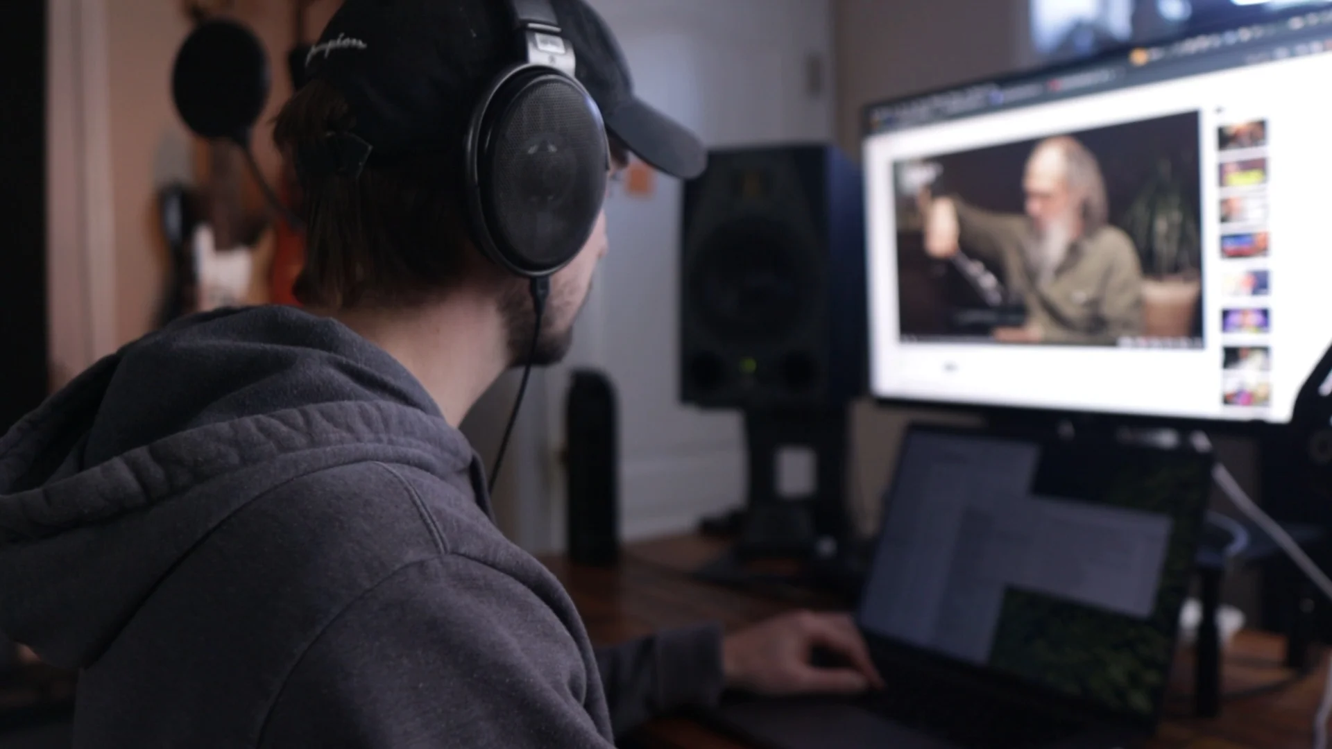 Mattie wearing headphones while editing audio content, demonstrating the process of blending vocals into the final mix