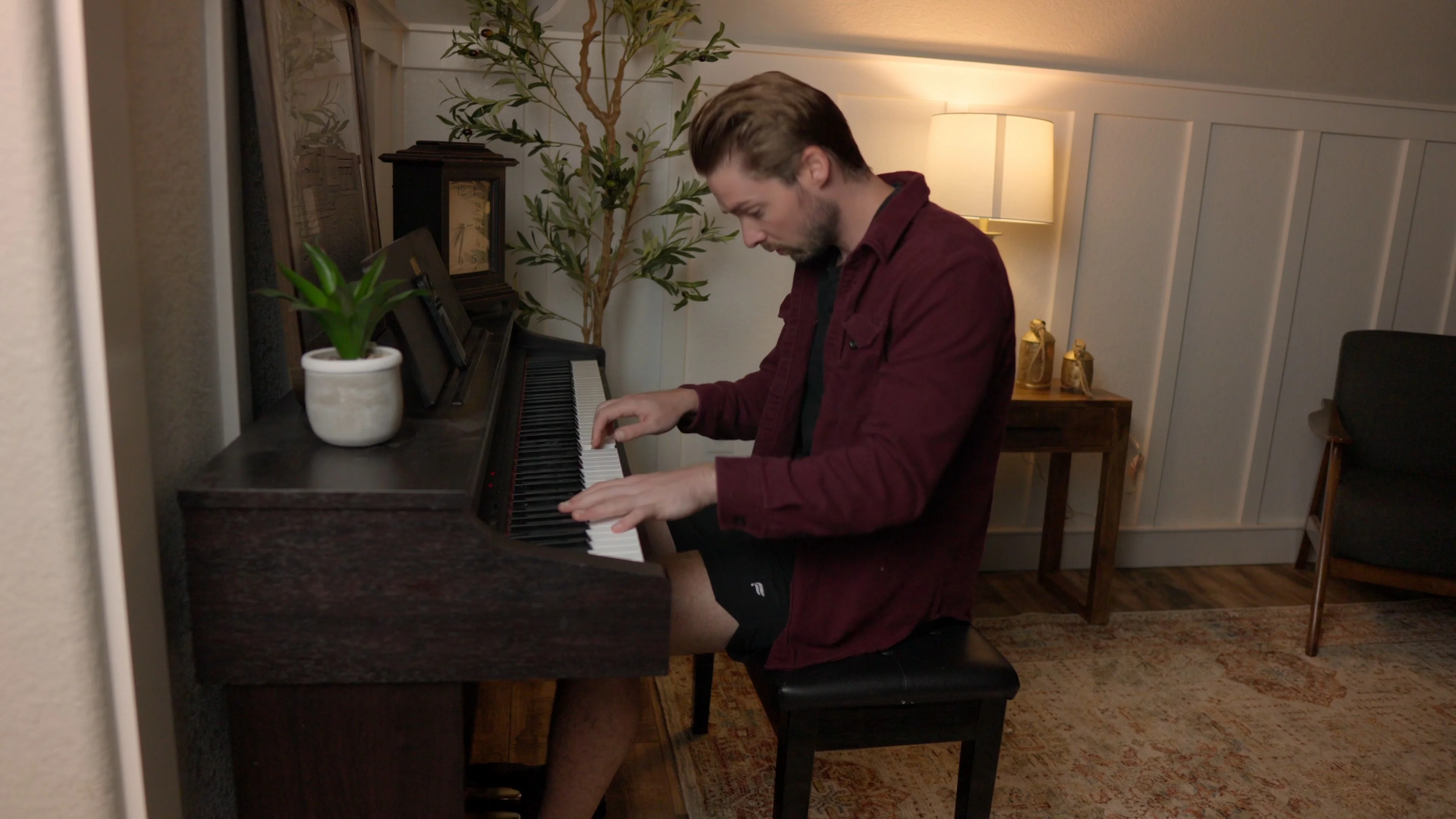 Mattie playing piano in home studio demonstrating rapid workflow with Logic Pro templates for quick song creation