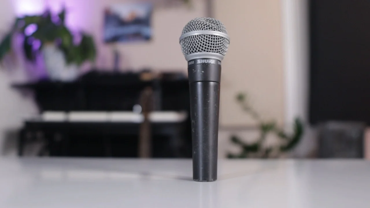 Professional Shure SM58 dynamic microphone positioned in home studio setup for vocal recording