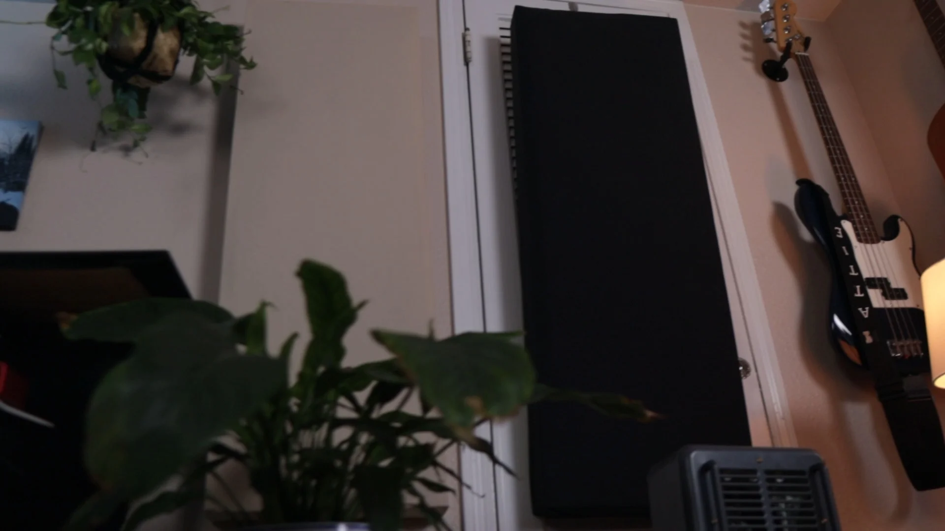 Home studio setup with black acoustic panels mounted on wall, essential for quality vocal recording before mixing